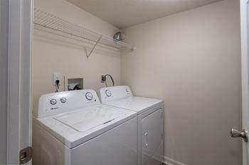 This is a photo of the utility room with washer and dryer in the 1226 square foot 3 bedroom, 2 bath Hambletonian at Trails of Saddlebrook Apartments in Florence, KY.