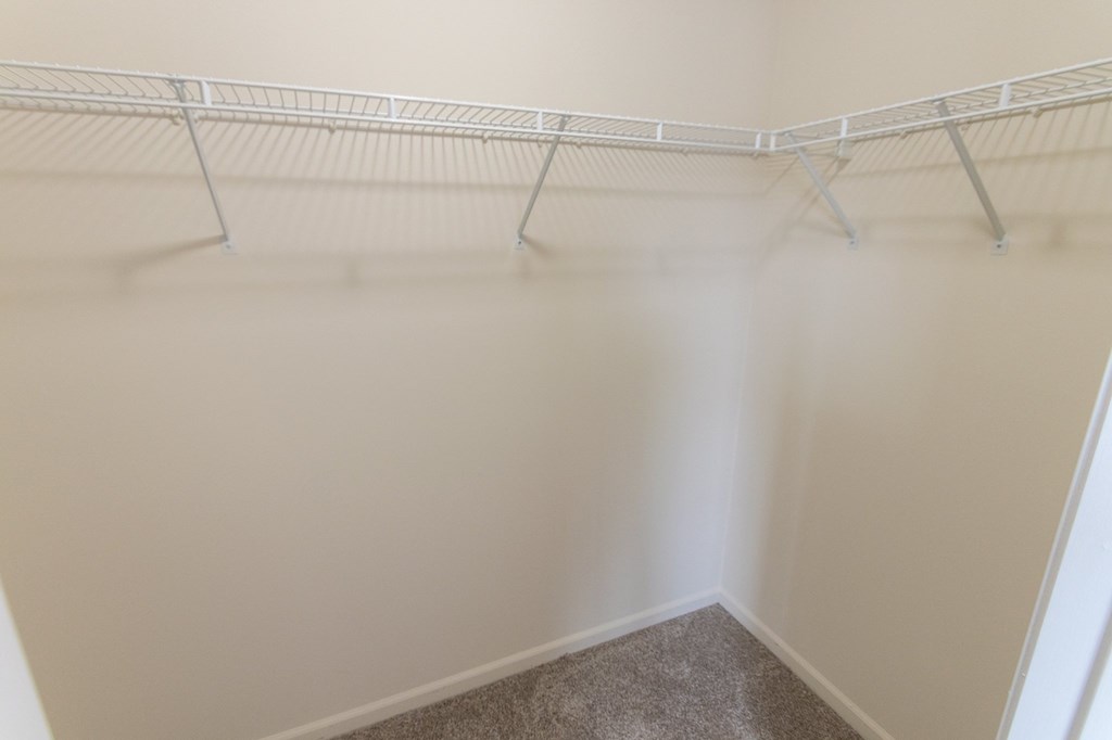 This is a photo of the primary bedroom walk-in closet in the 1226 square foot 3 bedroom Hambletonian at Trails of Saddlebrook Apartments in Florence, KY.