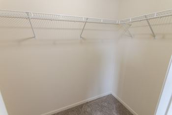 This is a photo of the master bedroom walk-in closet in the 1226 square foot 3 bedroom Hambletonian at Trails of Saddlebrook Apartments in Florence, KY.