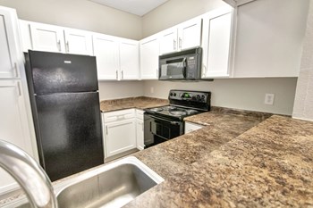 This is a photo of the kitchen in the 1110 square foot, lower 2 bedroom Serenity floor plan at The Sanctuary at Fishers Apartments in Fishers, IN. - Photo Gallery 4