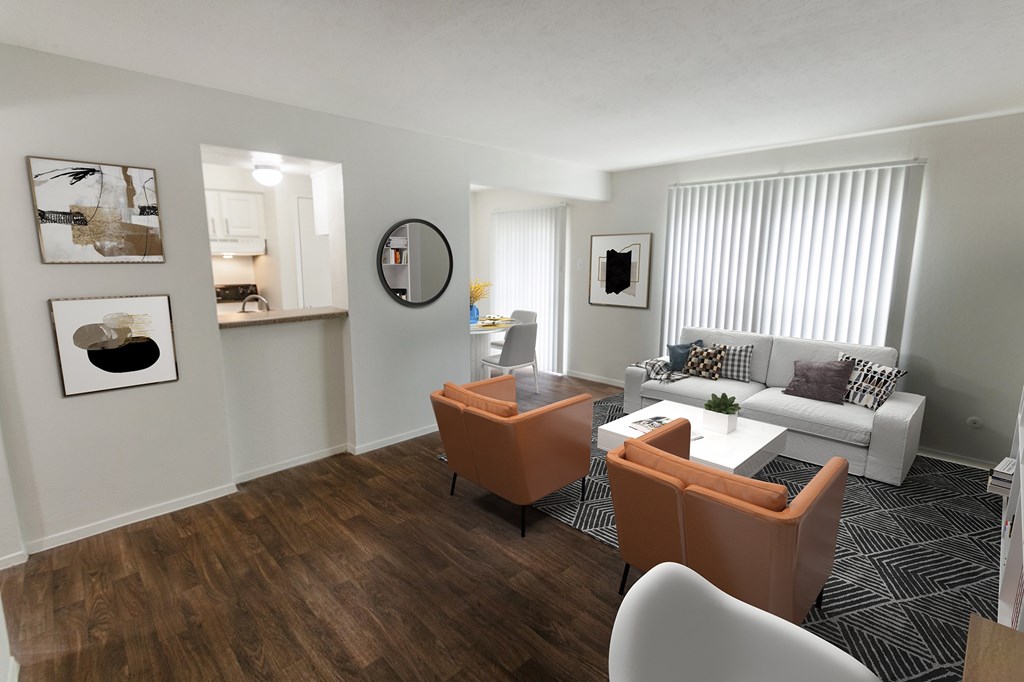A living room with a white couch and orange chairs.