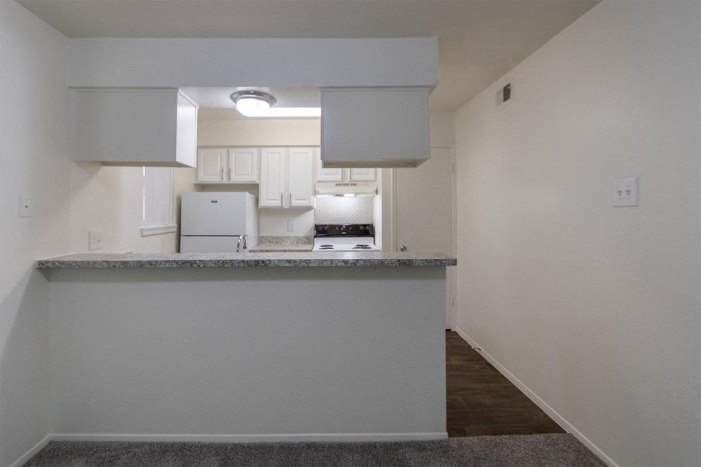 This is a photo of the kitchen in the 963 square foot 2 bedroom, 2 bath apartment at The Summit at Midtown Apartments in Dallas, TX.
