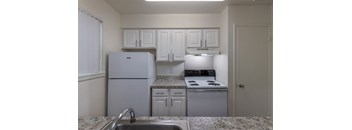 This is a photo of the kitchen in the 963 square foot 2 bedroom, 2 bath apartment at The Summit at Midtown Apartments in Dallas, TX.