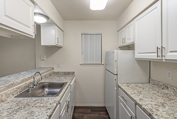 This is a photo of the kitchen in the 486 square foot 1 bedroom apartment at The Summit at Midtown Apartments in Dallas, TX. - Photo Gallery 4