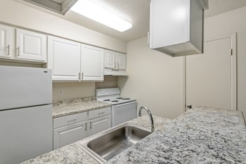 This is a photo of the kitchen in the 486 square foot 1 bedroom apartment at The Summit at Midtown Apartments in Dallas, TX. - Photo Gallery 3
