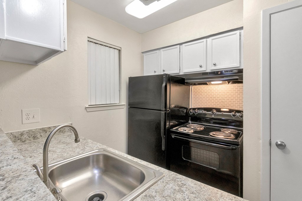 This is a photo of the kitchen in the 558 square foot 1 bedroom apartment at The Summit at Midtown Apartments in Dallas, TX.