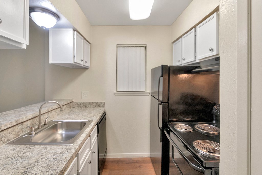 This is a photo of the kitchen in the 558 square foot 1 bedroom apartment at The Summit at Midtown Apartments in Dallas, TX.