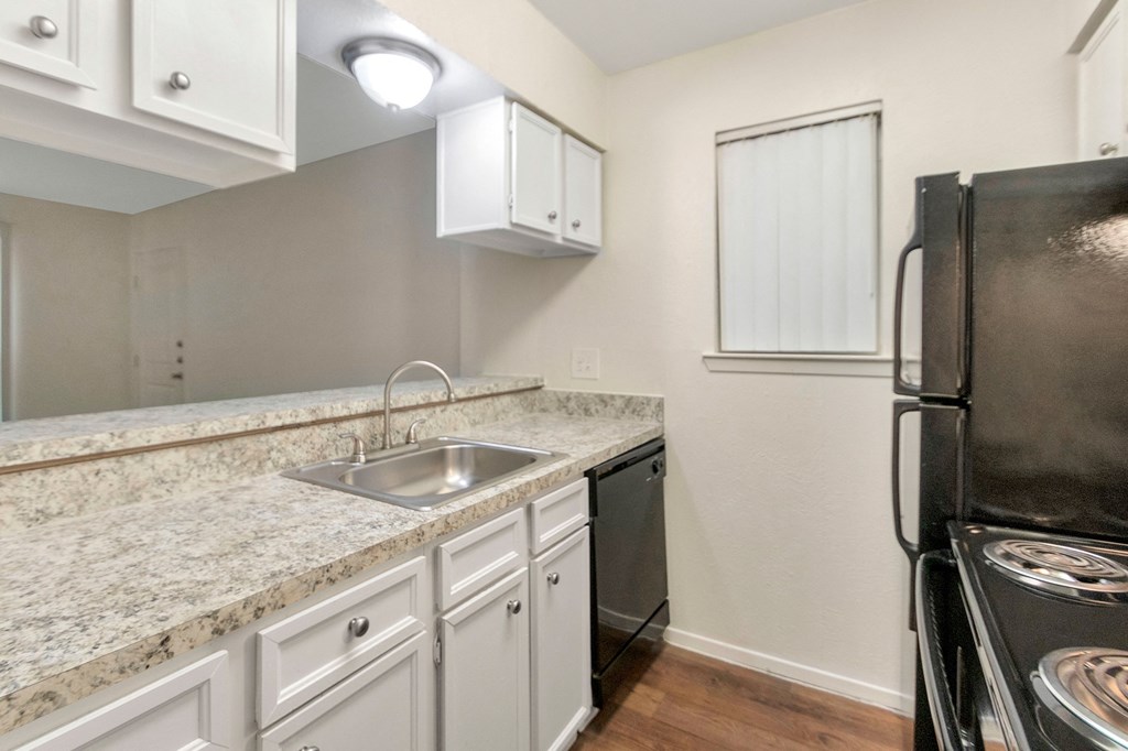 This is a photo of the kitchen in the 558 square foot 1 bedroom apartment at The Summit at Midtown Apartments in Dallas, TX.