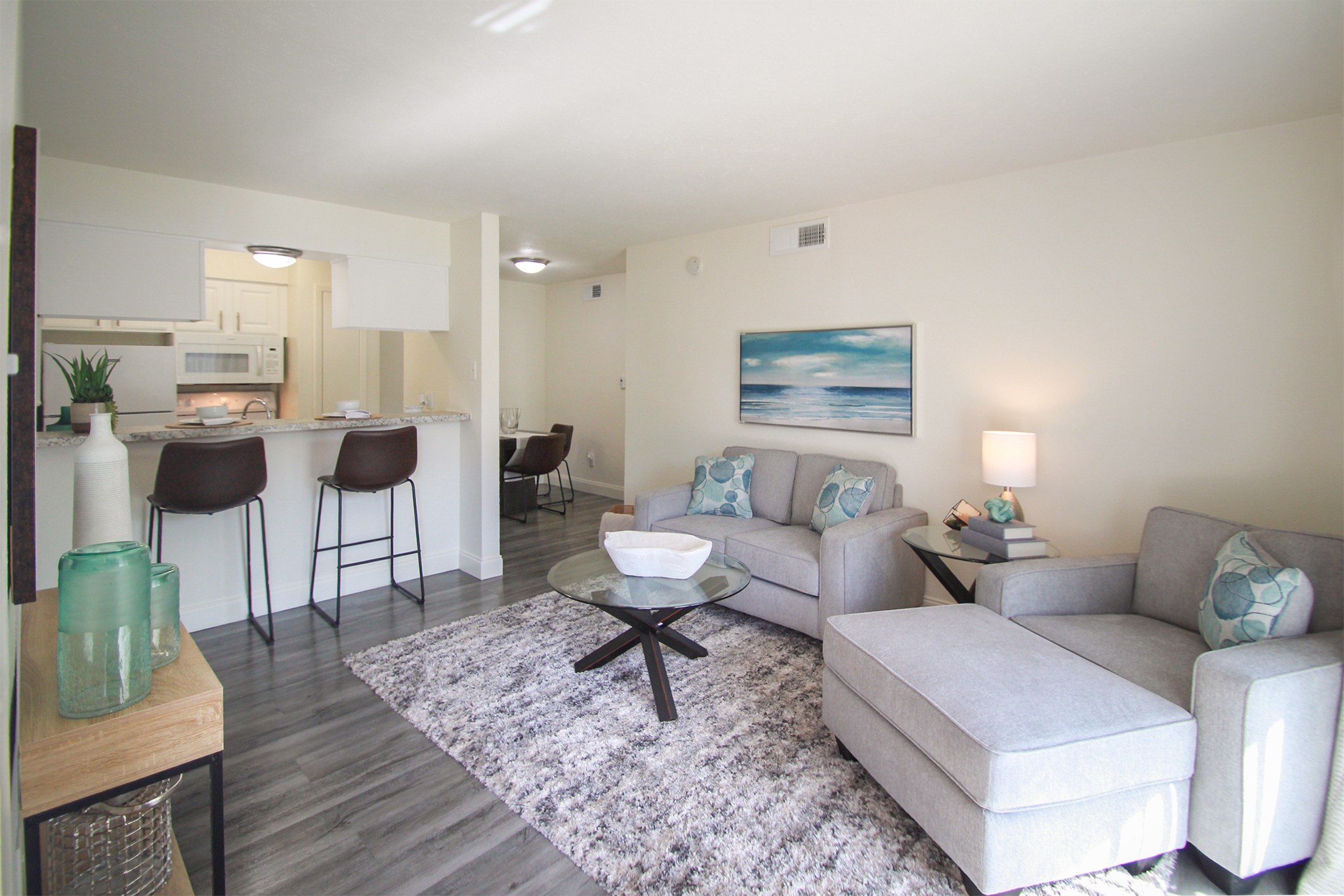 A living room with a grey couch and a coffee table.