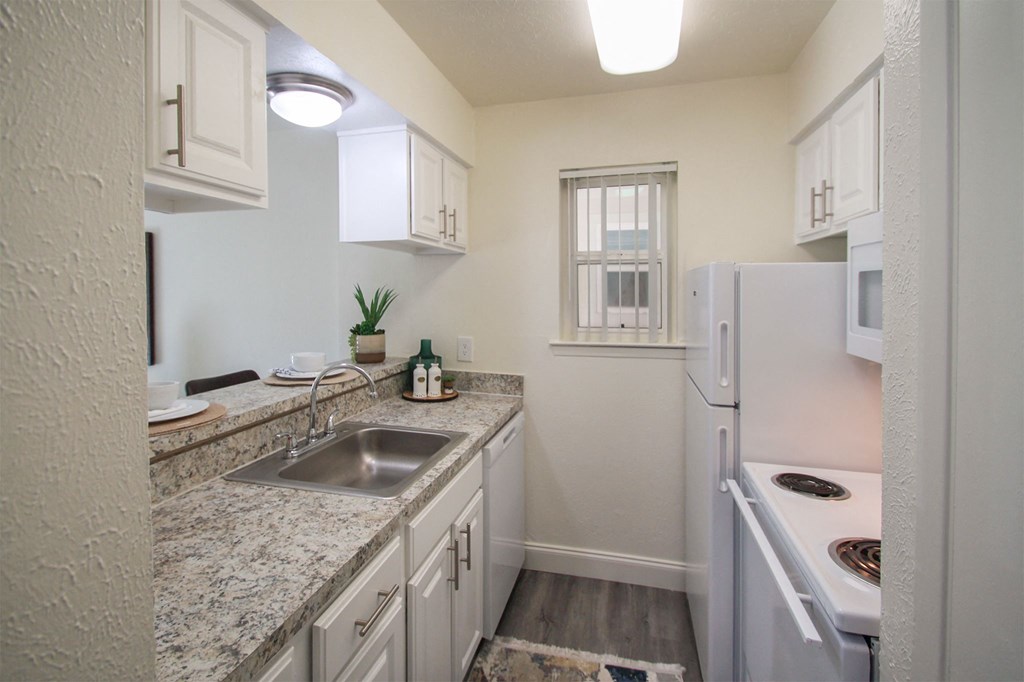 This is a photo of the kitchen in the 558 square foot 1 bedroom, 1 bath model apartment at The Summit at Midtown Apartments in Dallas, TX.