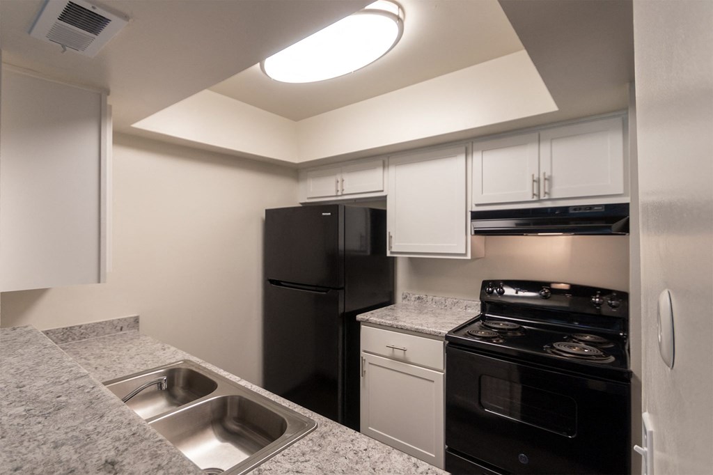 Kitchen With Black Appliances at Village East, Franklin, OH