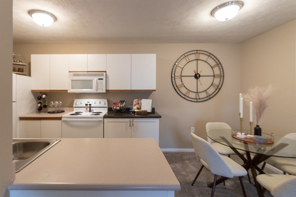 This is a photo of the kitchen and dining room of the 890 square foot 2 bedroom, 2 bath Liberty at Washington Place Apartments in in Miamisburg, Ohio in Washington Township.