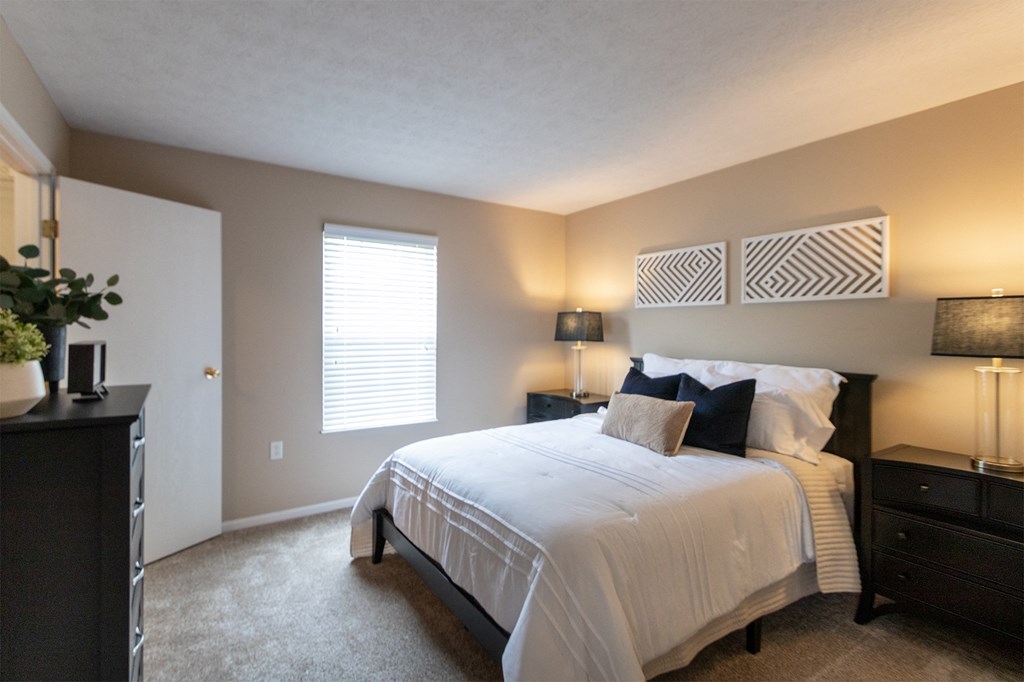 This is a photo of the primary bedroom of the 890 square foot 2 bedroom, 2 bath Liberty at Washington Place Apartments in in Miamisburg, Ohio in Washington Township.