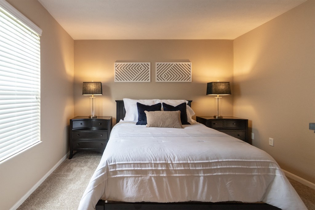 This is a photo of the primary bedroom of the 890 square foot 2 bedroom, 2 bath Liberty at Washington Place Apartments in in Miamisburg, Ohio in Washington Township.