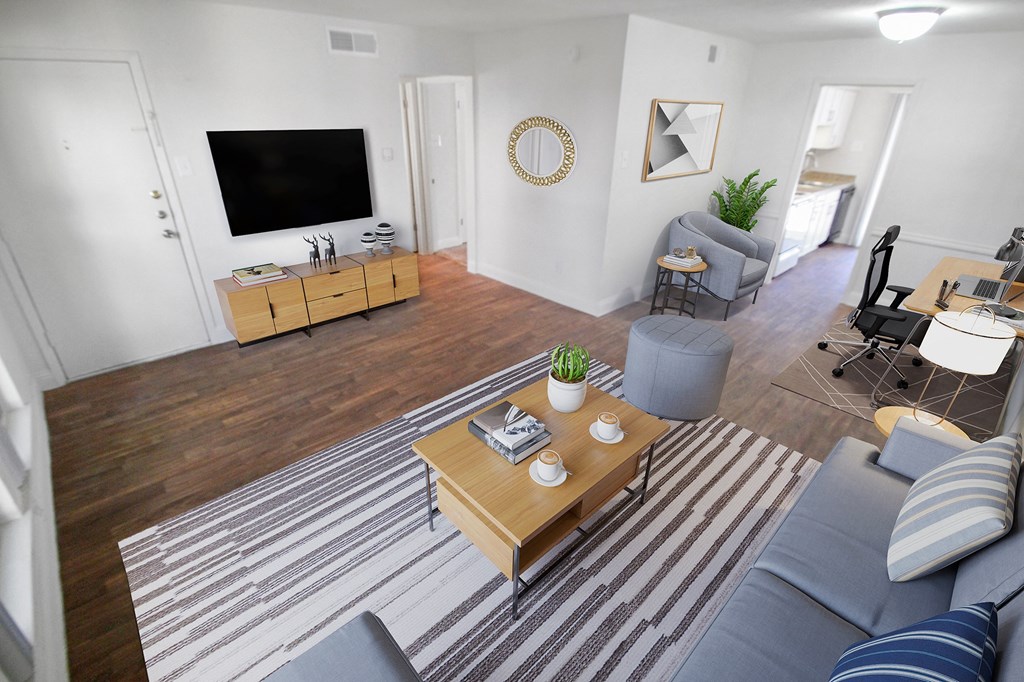 This is a photo of a virtually staged living room in the 751 square foot 1 bedroom, 1 bath apartment at Woodbridge Apartments in Dallas, TX.