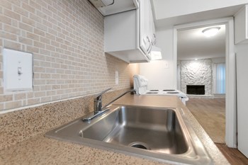 This is a photo of the kitchen in the 751 square foot 1 bedroom, 1 bath apartment at Woodbridge Apartments in Dallas, TX. - Photo Gallery 4