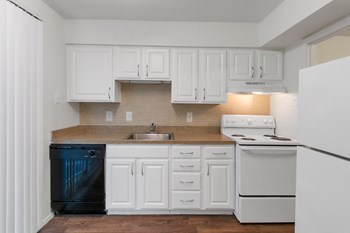 This is a photo of the kitchen in the 751 square foot 1 bedroom, 1 bath apartment at Woodbridge Apartments in Dallas, TX. - Photo Gallery 3