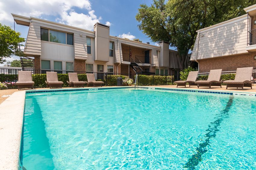 This is a photo of the pool area at Woodbridge Apartments in Dallas, Texas. - Photo Gallery 1