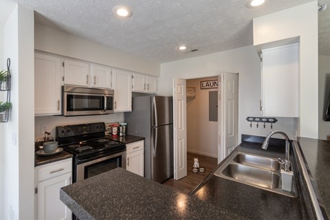 a kitchen with granite counter tops and stainless steel appliances