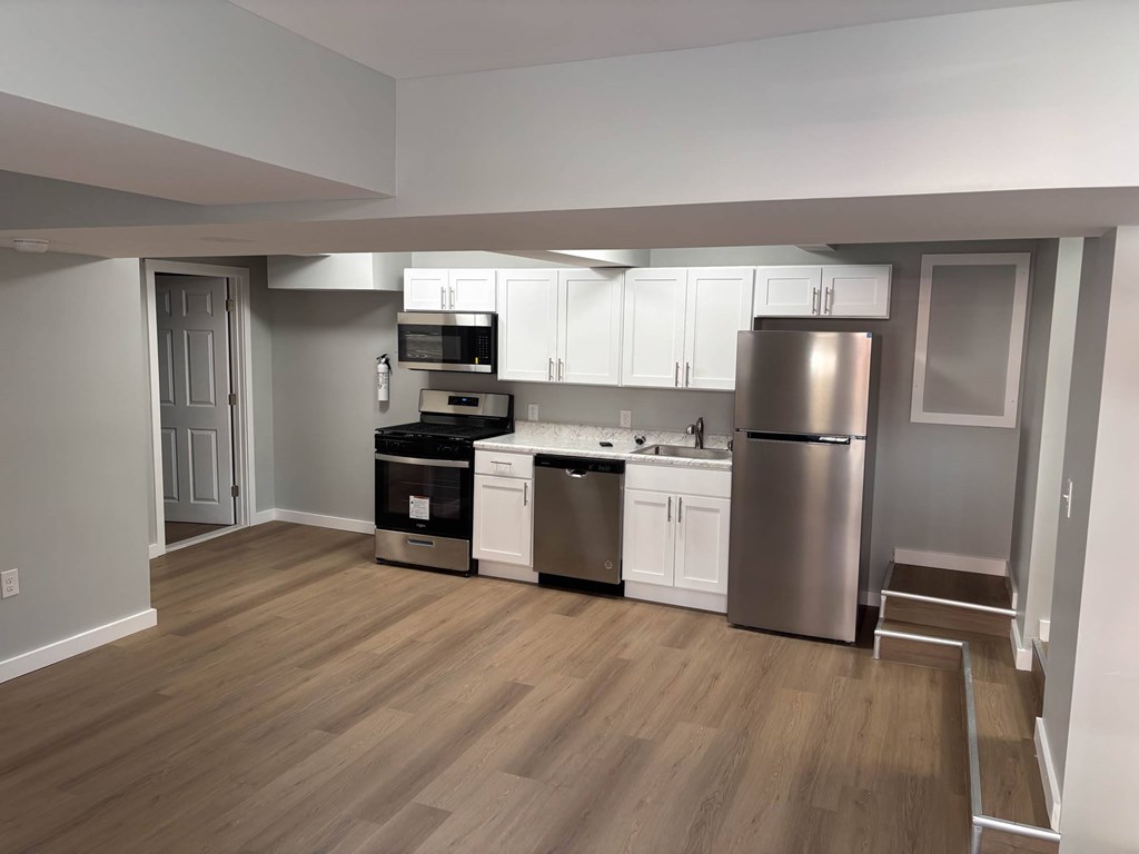 A kitchen with white cabinets and stainless steel appliances.at Lawndale Apartments, Pennsylvania