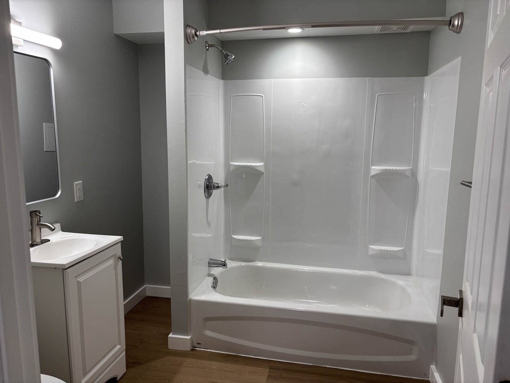 A white bathroom with a walk-in shower and a toilet.at Lawndale Apartments, Pennsylvania, 19111