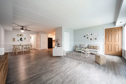 A spacious living room with a dining table and chairs.