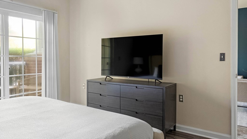 A bedroom with a bed, dresser, and a television.at Riverview Landing @ Valley Forge, Eagleville, 19403