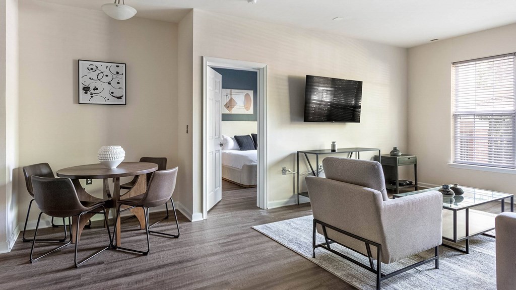 A living room with a grey couch, a white table, and a television.at Riverview Landing @ Valley Forge, Pennsylvania, 19403