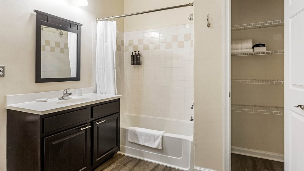 A bathroom with a white sink and a black vanity.at Riverview Landing @ Valley Forge, Eagleville, PA