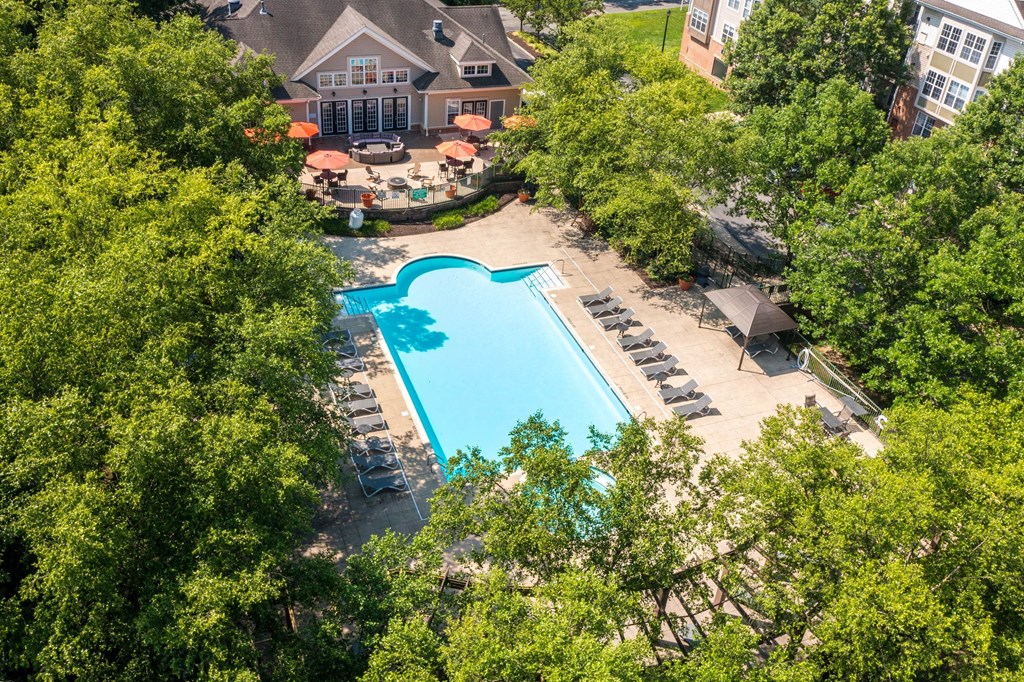 A large swimming pool surrounded by trees and a building in the background.at Riverview Landing @ Valley Forge, Pennsylvania, 19403