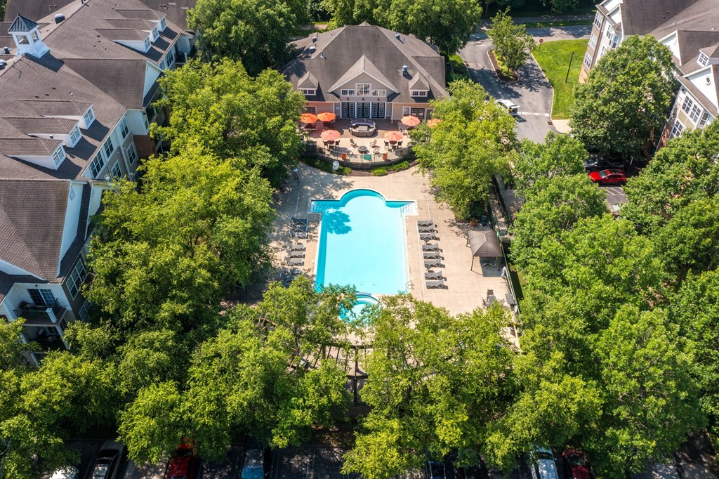 A swimming pool surrounded by trees and houses.at Riverview Landing @ Valley Forge, Eagleville