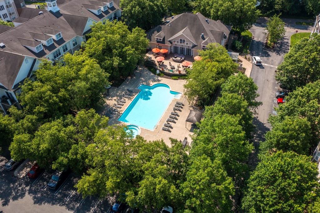 A swimming pool surrounded by trees and houses.at Riverview Landing @ Valley Forge, Pennsylvania, 19403