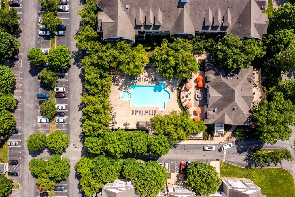 An aerial view of a parking lot with a swimming pool and trees.at Riverview Landing @ Valley Forge, Pennsylvania, 19403