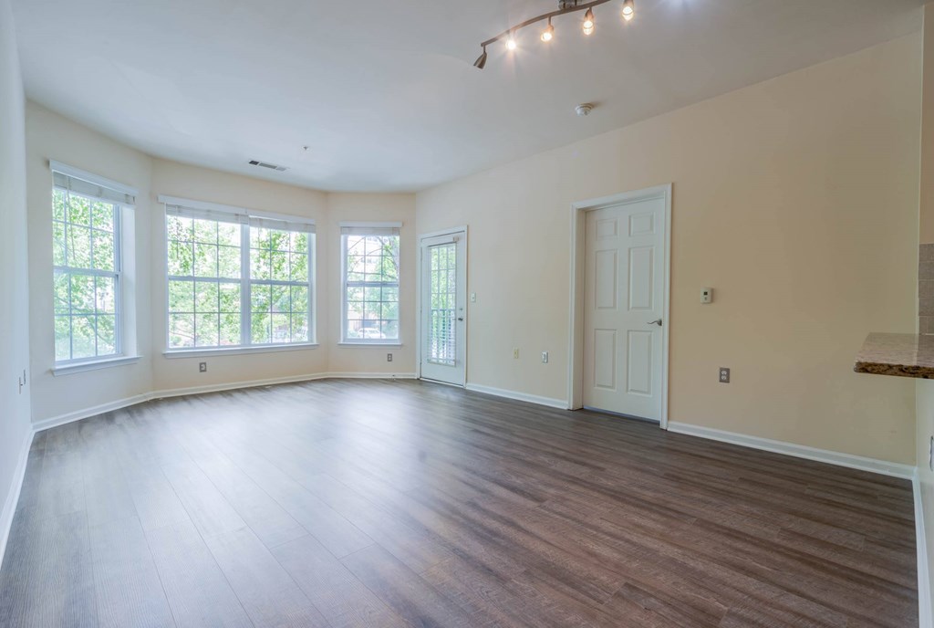 A large empty room with wooden floors and white walls.at Riverview Landing @ Valley Forge, Pennsylvania