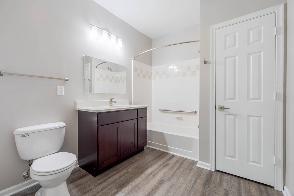 A white toilet is next to a sink in a bathroom.at Riverview Landing @ Valley Forge, Eagleville, PA