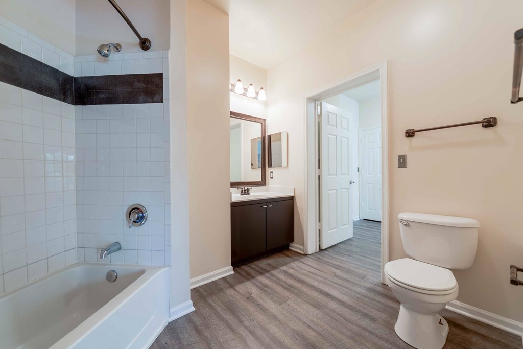 A white toilet sits next to a bathtub in a bathroom.at Riverview Landing @ Valley Forge, Eagleville, PA