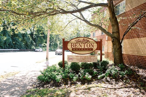 a sign for the benoit restaurant in front of a brick building