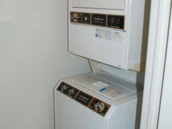 a white refrigerator and a washer and dryer in a room at Brookshire Trace Townhomes Apartments, Philadelphia, PA, 19116