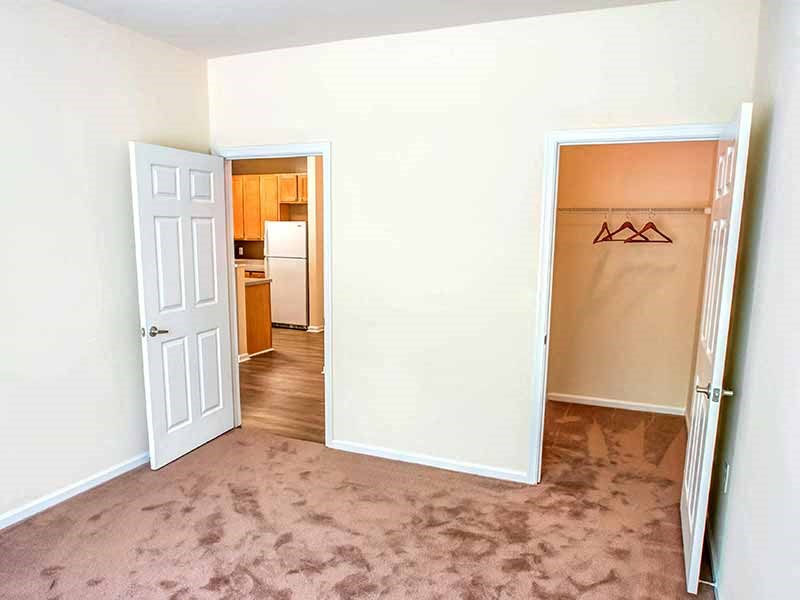 an empty room with a door to a closet and a kitchen at Riverview Landing @ Valley Forge, Eagleville Pennsylvania