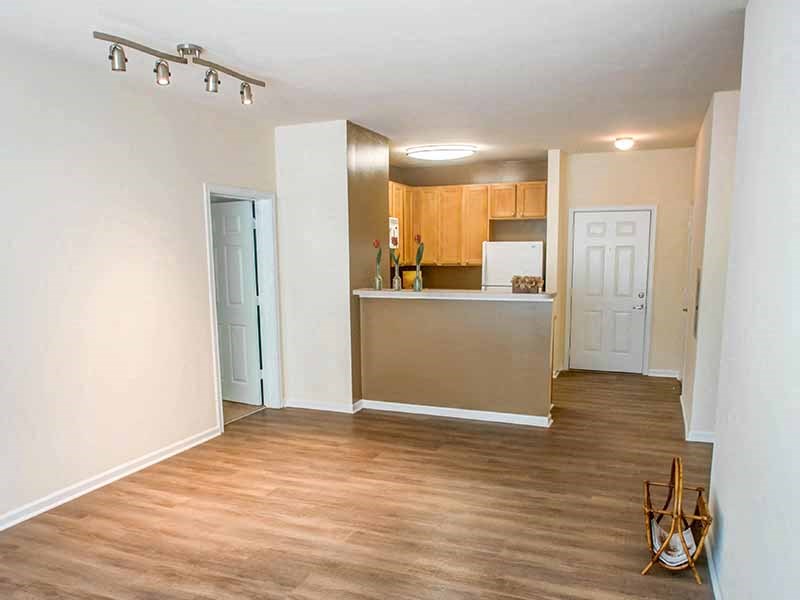 an empty living room and kitchen with a wood floor at Riverview Landing @ Valley Forge, Eagleville