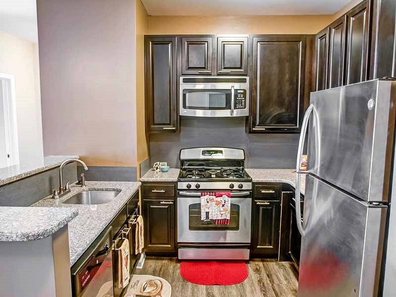 a kitchen with stainless steel appliances and wooden cabinets at Riverview Landing @ Valley Forge, Eagleville Pennsylvania