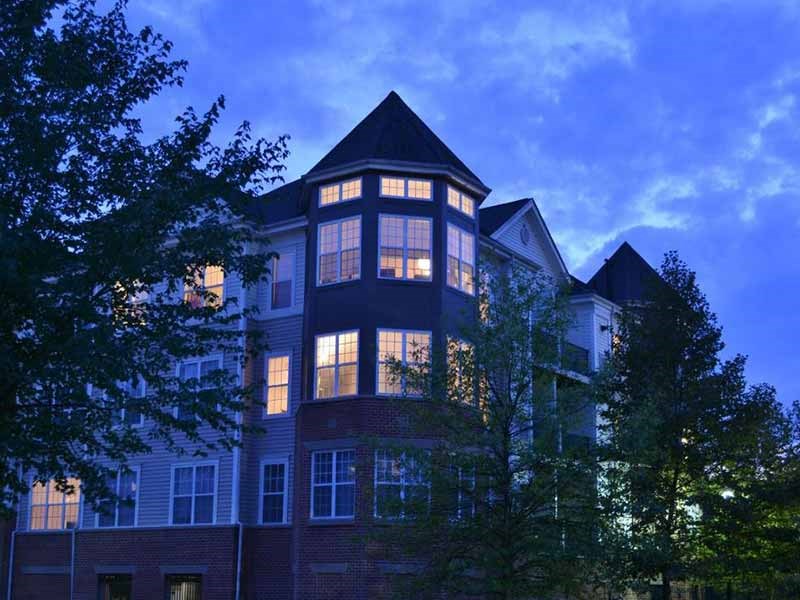 a large building with lights on at duskat Riverview Landing @ Valley Forge, Eagleville Pennsylvania