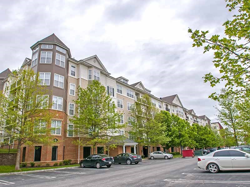 a large apartment building with cars parked in a parking lot at Riverview Landing @ Valley Forge, Pennsylvania