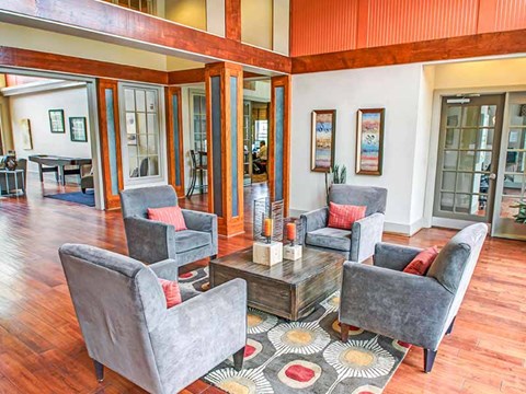 A living room with grey chairs and a coffee table.