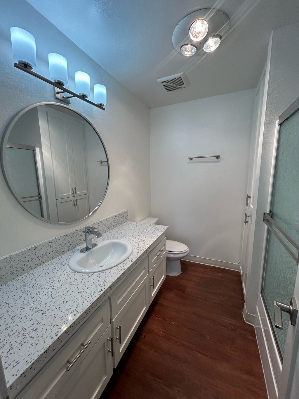a bathroom with a sink and a toilet and a mirror at Camino de Oro Apartments, Torrance, CA, 90505