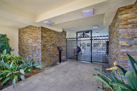 the entrance to a building with a gate at Olive Tree Apartments, California