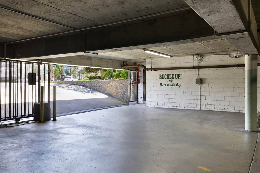 the inside of a parking garage with a gate at Camino de Oro Apartments, Torrance, CA, 90505