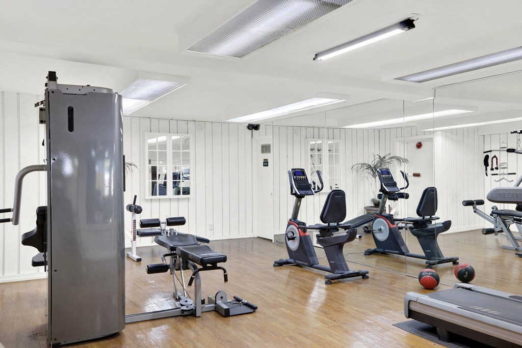 the gym has plenty of exercise equipment and a treadmill at Camino de Oro Apartments, Torrance, California