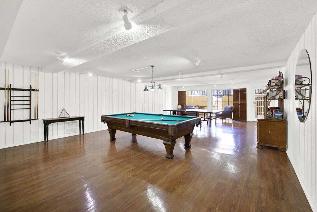 a room with a pool table in the middle of it at Camino de Oro Apartments, Torrance, California