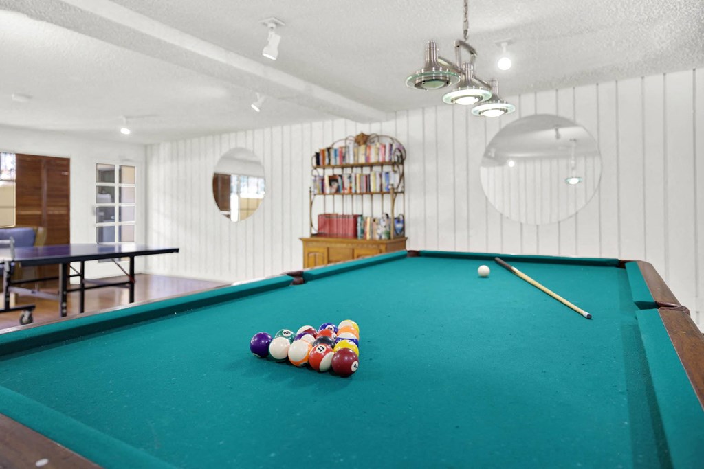 a pool table in a room with balls on it at Camino de Oro Apartments, Torrance, CA